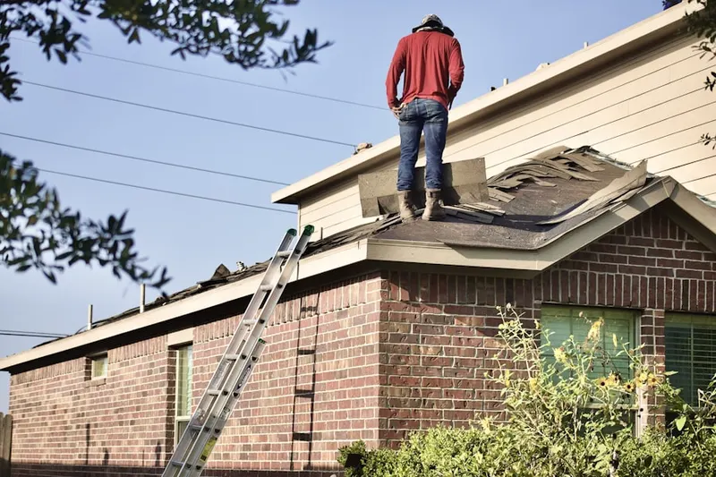 Professional roofer working on a residential roof in East Greenville